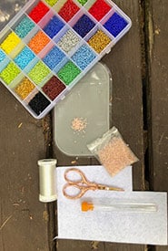These are my beading basics: bead mat, beading needles, stiffened felt, clear beading string and colourful seed beads (Photo Raechel Wastesicoot/NCC)